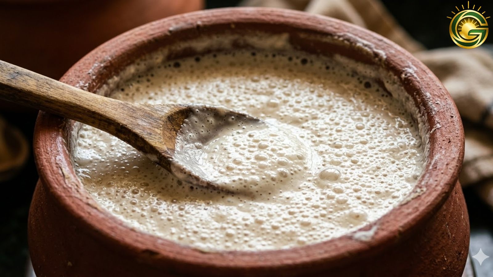 Close-up of fermented dosa batter in a clay pot filled with air bubbles, ready for Crispy Masala Dosa Recipe.